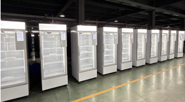 A row of TCN AI smart cooler vending machines on the factory production line, undergoing quality inspection before global distribution.